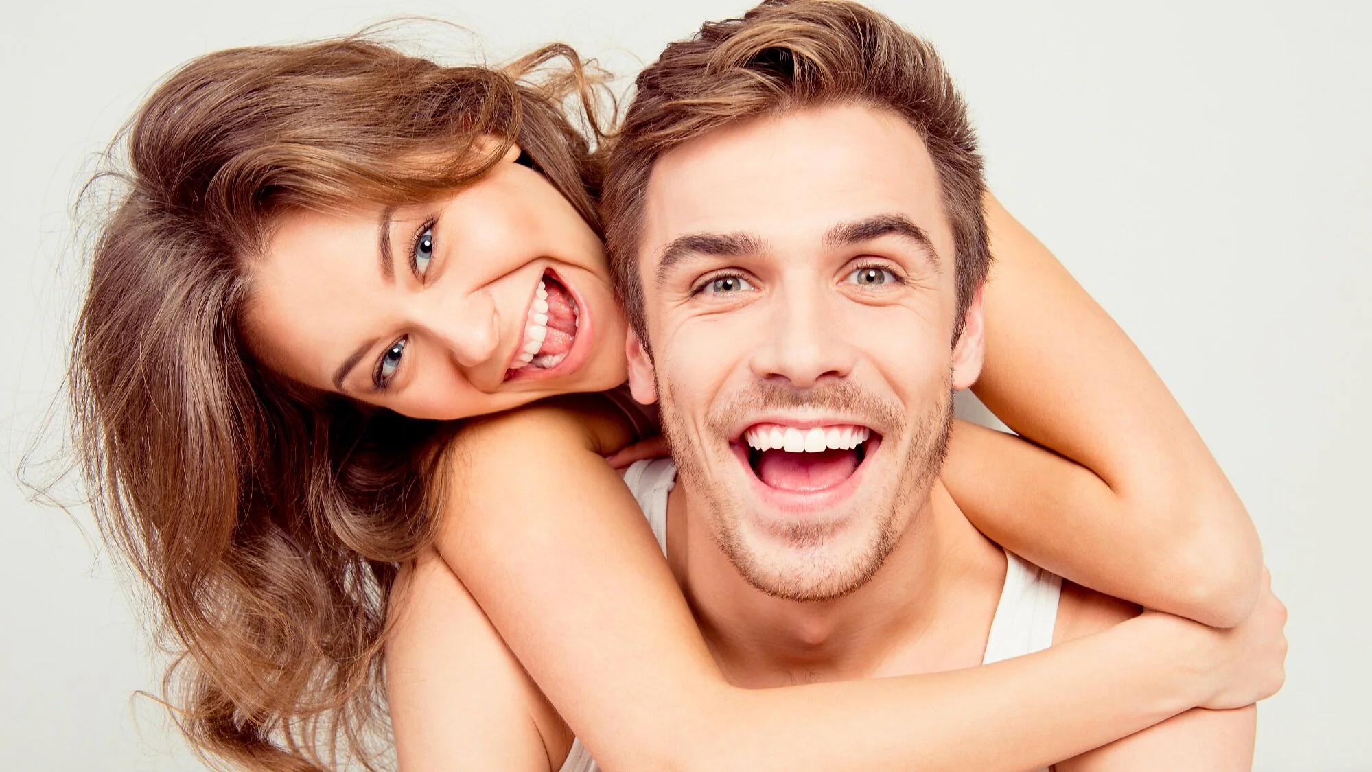 Couple laughing with confident smiles